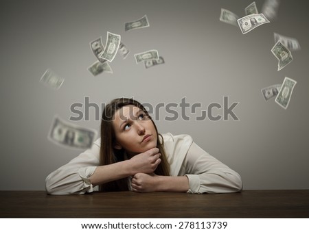 Girl in white and falling dollar banknotes. Currency and lottery concept. 