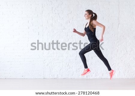 Side view of active sporty young running woman runner athlete with copy space concept sport health fitness loss weight cardio training jog workout wellness. Royalty-Free Stock Photo #278120468