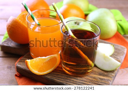 Assortment of healthy fresh juices and fruits on wooden table background