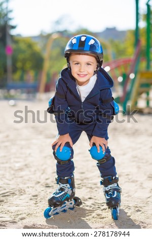 Smiling skater boy posing on the playground