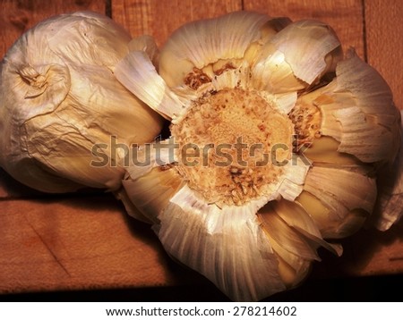 Royalty Free Photograph - Two Organic Cloves of Aromatic Fresh Garlic - Isolated on Wooden Table