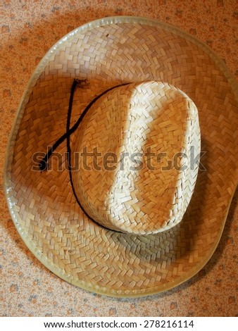 Royalty Free Photograph - The Farmer's Classic Straw Hat hanging on a Country Kitchen Wall