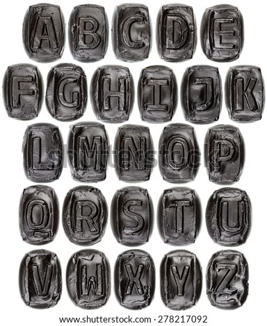 Handmade ceramic letter alphabet painted in black isolated on white