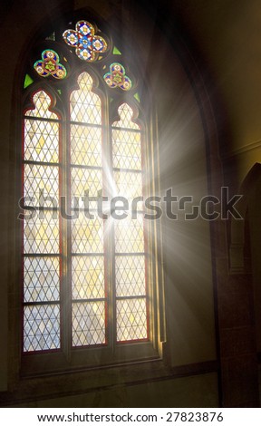 Church stained-glass window with sunlight shining through