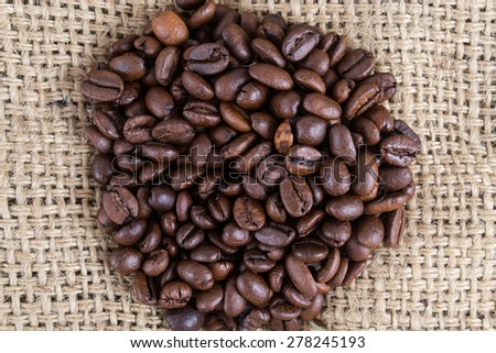 Coffee beans on the canvas background