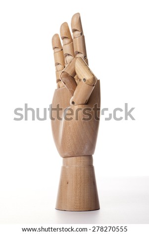 A hand of wood doll make two fingers three(chinese style) isolated white background at the studio.
