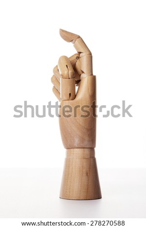 A hand of wood doll make index finger(forefinger) direction, one(1) isolated white background at the studio.
