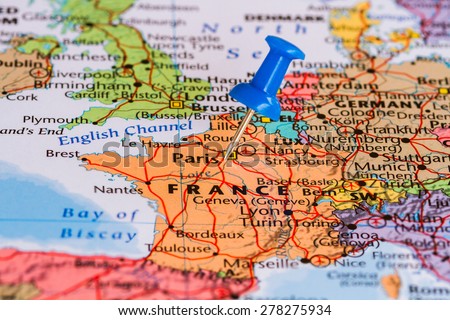 Map of France with a blue pushpin stuck Royalty-Free Stock Photo #278275934