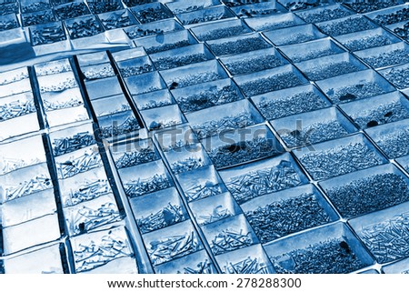 metal parts and fasteners in a iron box, closeup of photo