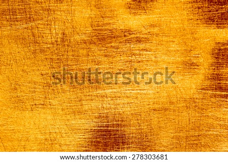 Scratches on a metallic gold background.