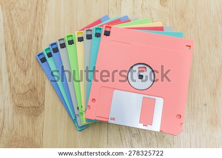 Stack of colorful floppy disks on a wooden table