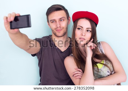 two women and man friends taking selfie together wearing summer clothes  jeans shorts jeanswear street urban casual style having fun