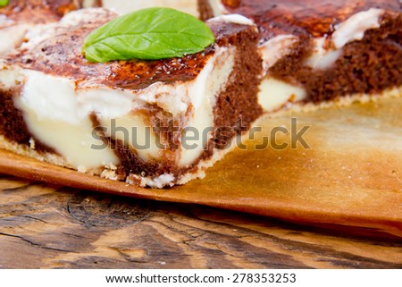 Photo of sliced cream cake on wooden board