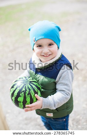 Little boy with ball on playground