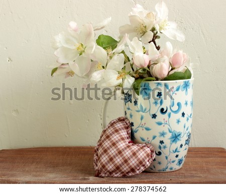 Composition with flowers in a cup with white background