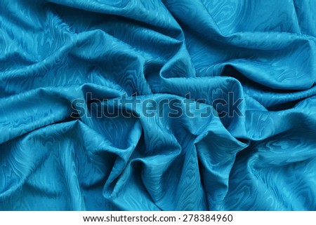 Blue cyan silk damask fabric with wavy texture.