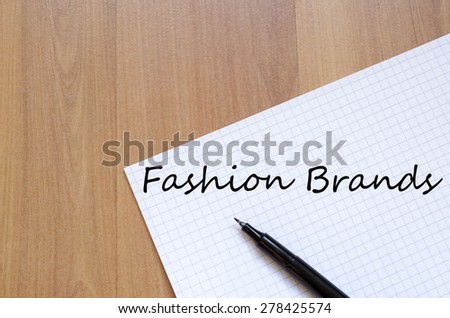White blank notepad on office wooden table Fashion brands concept