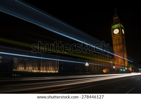 Big Ben, one of the most prominent symbols of both London and England, as shown at night along with the lights of the cars passing by