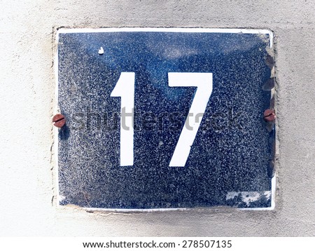 Image of the number 17 on a wall indicating a house number