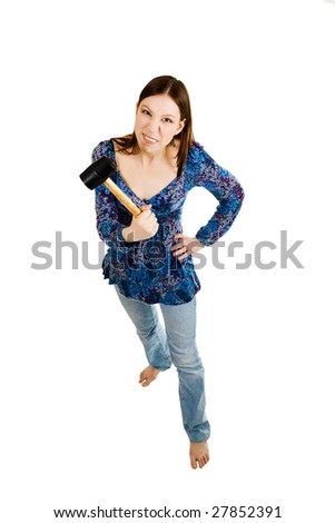 Aggressive woman holding hammer in her hand and looking straight