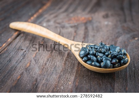 Black beans on wooden background - vintage effect style pictures