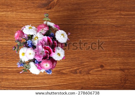 Colorful daisy on wooden table, top view