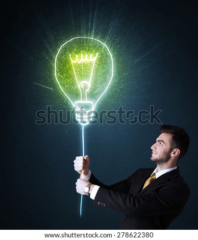 Businessman hold a shining idea bulb on a blue background