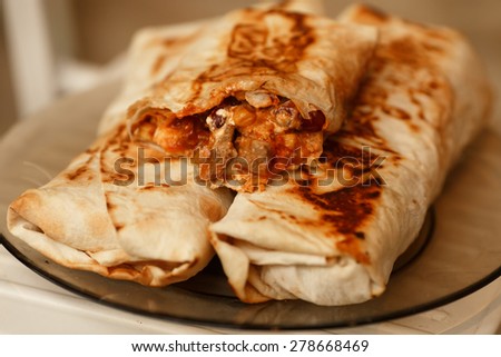 Burrito mexican fast food, spicy burritos snack, lunch tortilli, unhealthy eating, selective focus, series.