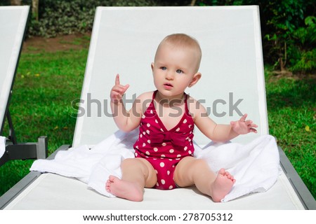 Cute happy baby relaxing at pool