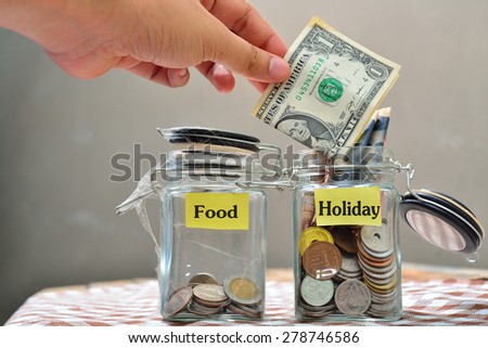 glass jars with coins and 'holiday' text