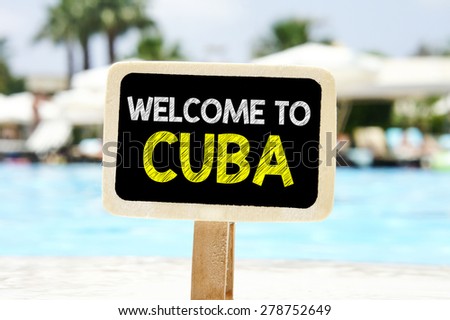 Welcome to Cuba on chalkboard. Welcome to Cuba text written on chalkboard near pool