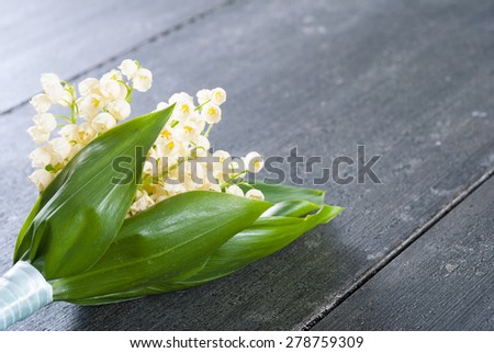 lily of the valley flowers bunch on black wooden table