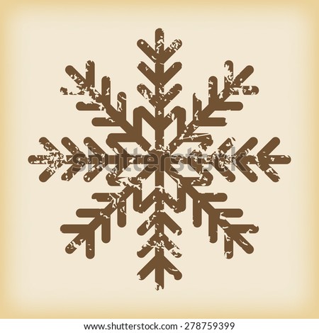 Grungy brown icon with image of snowflake, on beige background