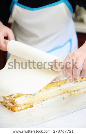 chef put mastic on the cake, close-up