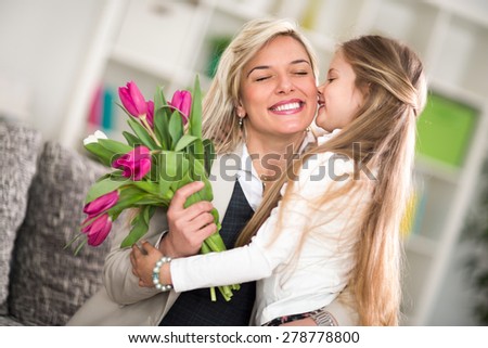 
Little girl  giving flowers to his mom on mother's day