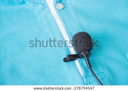 Close-up of  holding a Wireless lavalier microphone