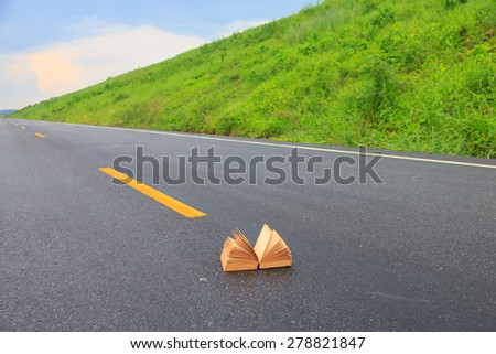 Open book on road outdoors