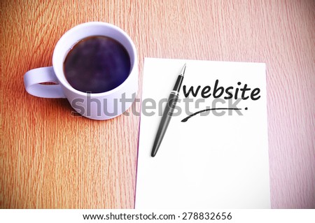 Business Concept - Steamy Coffee And Black Pen With White Paper Written Website.