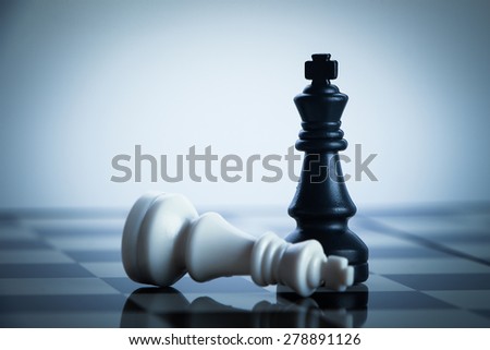 Checkmate black chess defeats white king on the chess board. Royalty-Free Stock Photo #278891126