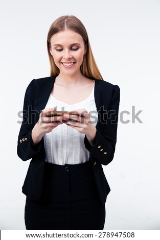 Happy young businesswoman using her smartphone over gray background