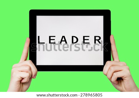 Tablet pc with text Leader with green background