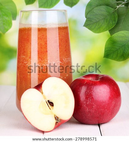 Fresh apple juice on nature background