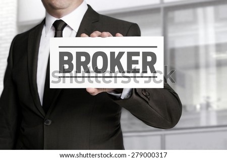 Broker sign is held by businessman Royalty-Free Stock Photo #279000317