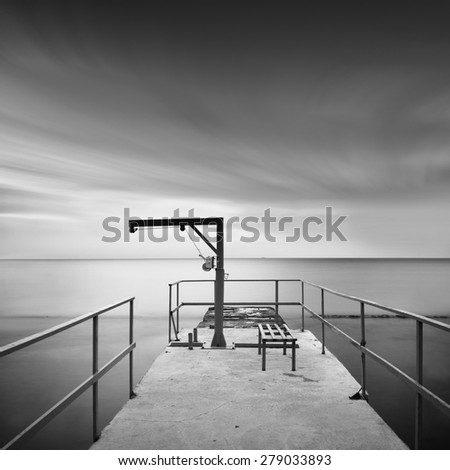 beautiful minimalist black and white seascape with sea wave cutter and milk water. shot taken in daytime with long exposure