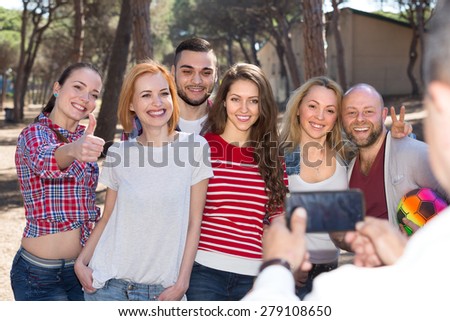 Happy smiling adults relaxing outdoors and doing selfie 

