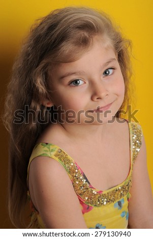 Cute girl on a yellow background