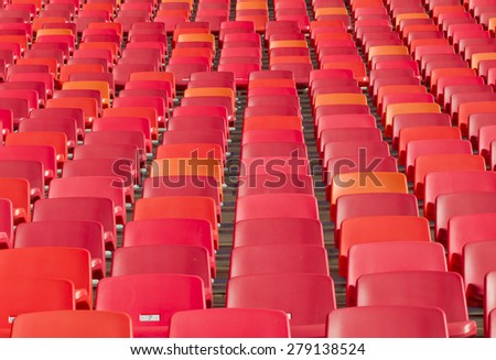tightly packed empty chairs in a sports stadium