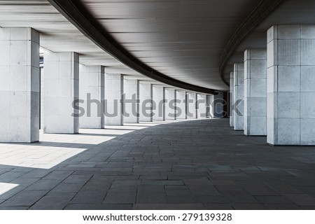 long corridor of a building with columns, monochrome background