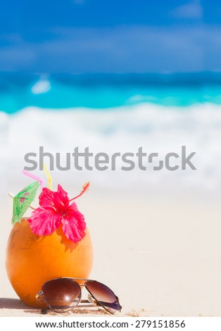 picture of fresh coconut juice and sunglasses on tropical beach