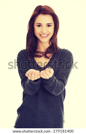 Woman showing something or copyspase for product or sign text